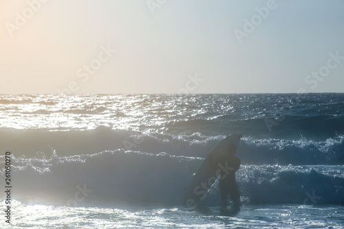 Young man, beginner Surfer learns to surf on a sea foam on the Crete island, beach Falasarna photo