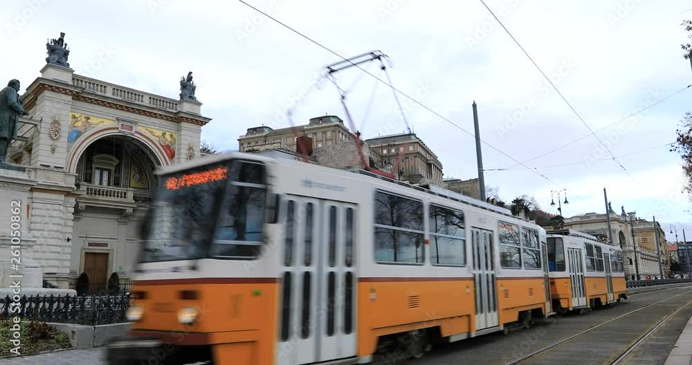 Yellow tram passes near the Danube river at winter time Yellow tram passes near the Danube river at winter time