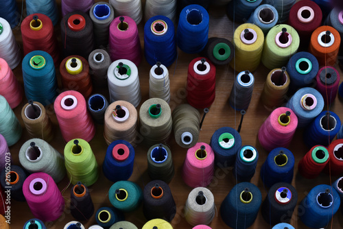 multi-colored spools of thread at a sewing workshop stand
