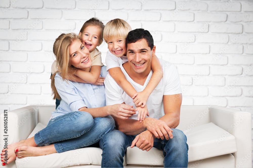 Beautiful smiling family in room on couch Beautiful smiling family in room on couch