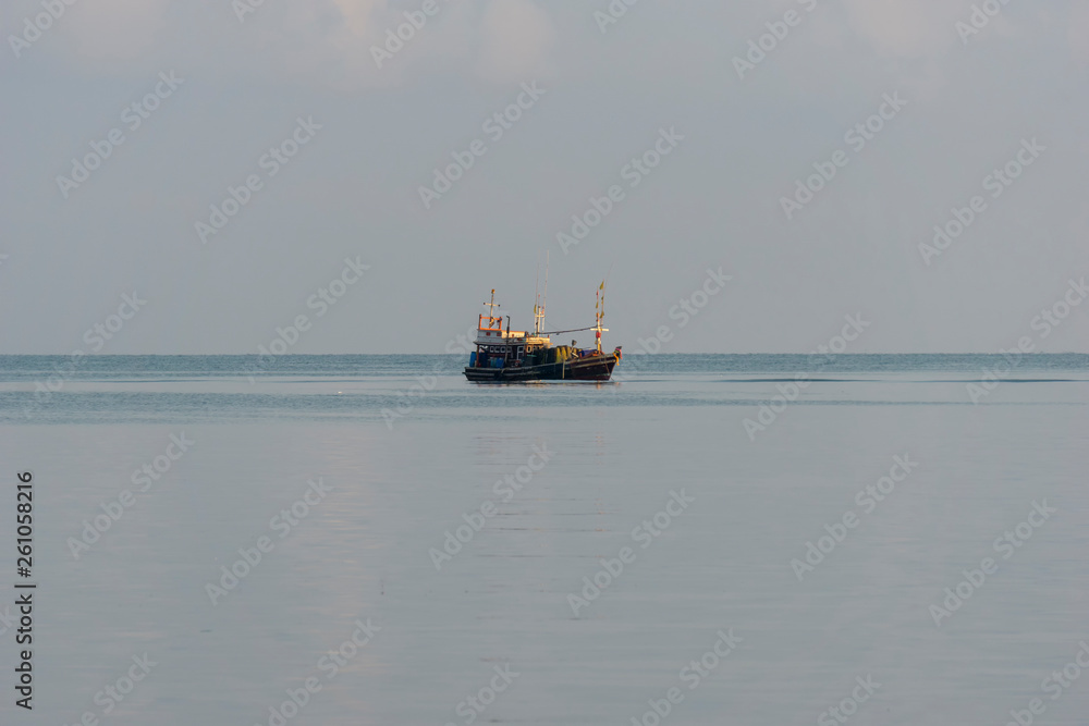 A small fishing boat is anchored. Stop back from Fishing near the coast A small fishing boat is anchored. Stop back from Fishing near the coast