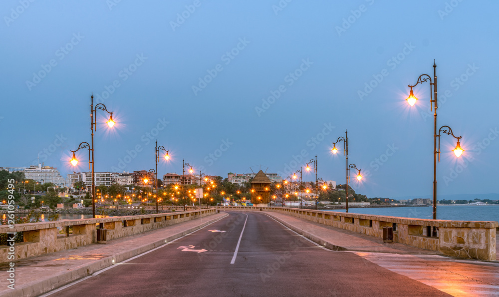 The Windmill on the street leading to Nessebar ancient city at sunrise on the Bulgarian Black Sea Coast. Nesebar or Nesebr is a UNESCO World Heritage Site. Isthmus leading to Nessebar