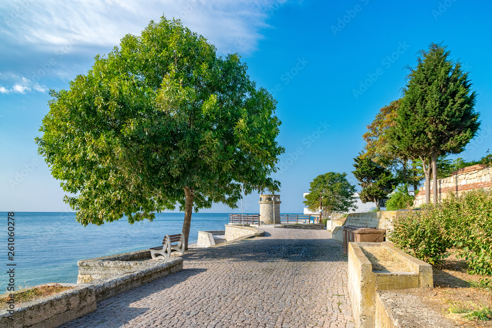 A beautiful street in Nessebar ancient city on the Bulgarian Black Sea Coast. Nesebar or Nesebr is a UNESCO World Heritage Site. A street in Nessebar on a sunny day with blue sky, Bulgaria