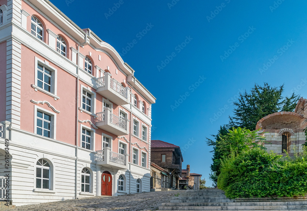 Fototapeta premium A street in Nessebar ancient city on the Bulgarian Black Sea Coast. Nesebar or Nesebr is a UNESCO World Heritage Site. A street in Nessebar on a sunny day with blue sky