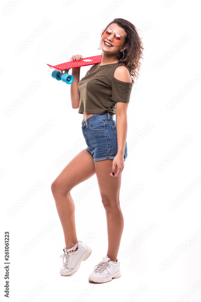 Full length portrait of a happy excited woman riding a skateboard isolated over white background Full length portrait of a happy excited woman riding a skateboard isolated over white background