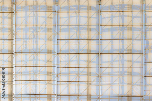 A roof of a building. The shadow of the frame on the roof which is transparent.