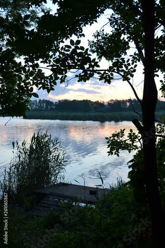 Fototapeta Naklejka Na Ścianę i Meble -  Dawn on the lake splashing in the water