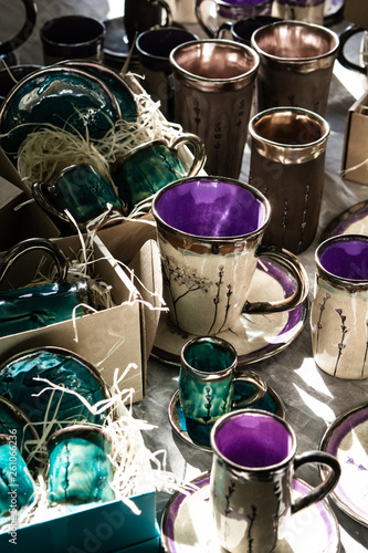 Ceramic and porcelain crafts, plates cups and bowls. Hand made dishes on a spring festival market.