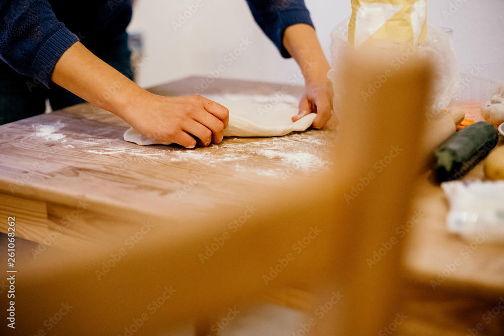 female hands kneading dough in order to make a pizza female hands kneading dough in order to make a pizza