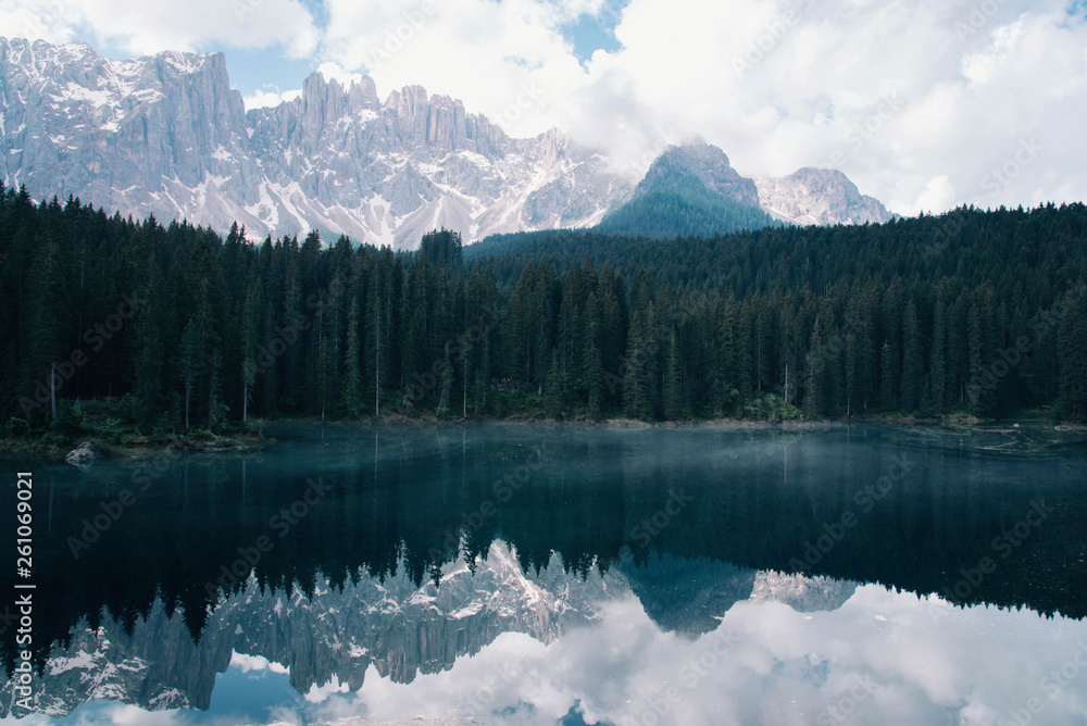 The Karersee lake with reflection of mountains in the Dolomites.