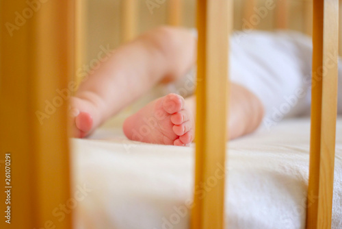 Infant baby is sleeping in his crib. Importance of sleep for babies. Sleep mode babies 5 months.