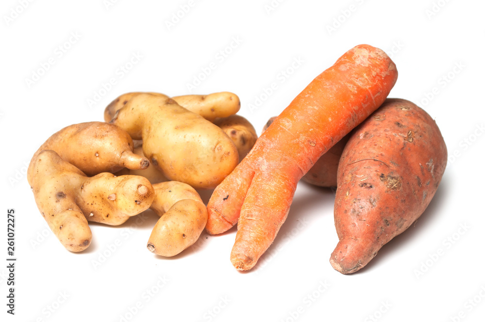 closeup of deformed vegetables on white background closeup of deformed vegetables on white background
