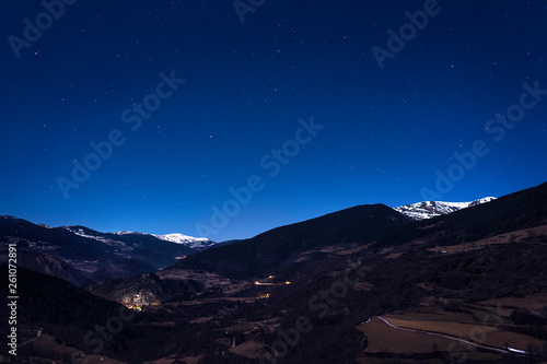 mountain landscape under night sky full of stars