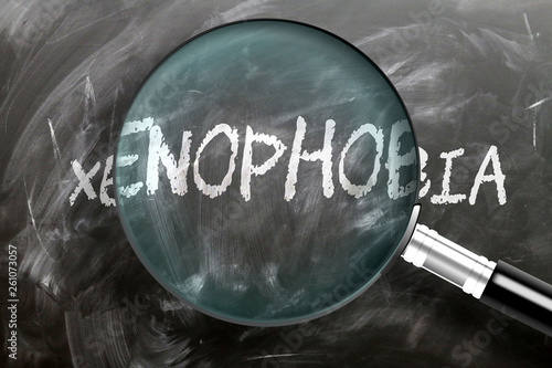 Learn, study and inspect xenophobia - pictured as a magnifying glass enlarging word xenophobia, symbolizes researching, exploring and analyzing meaning of xenophobia, 3d illustration