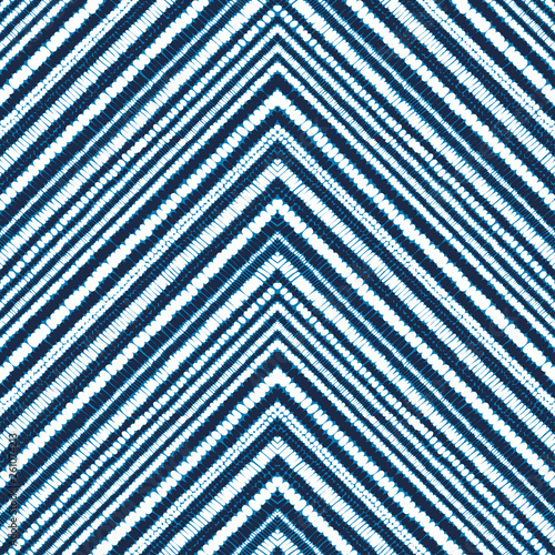 Seamless blue-white shibori pattern. Horizontal stripes zig zag. Print for textiles drawn by hand. Doodle horizontal pattern, polka dot. Vector illustration