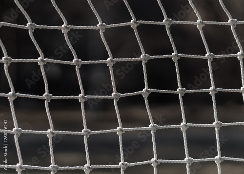 Football net close up. Interlacing white ropes. Old soccer gate.