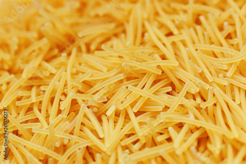 Background texture and pattern of boiled egg noodles or spaghetti pasta in full-frame format. View from above. Close-up