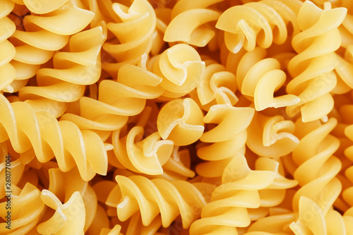 Background texture and pattern of boiled egg noodles in a spiral or pasta spaghetti screw. in full frame. View from above