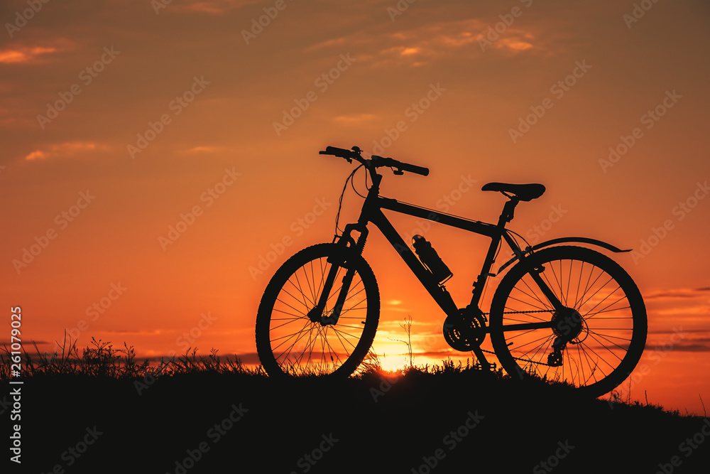 Silhouette of a male mountainbiker at sunset in the mountains Silhouette of a male mountainbiker at sunset in the mountains