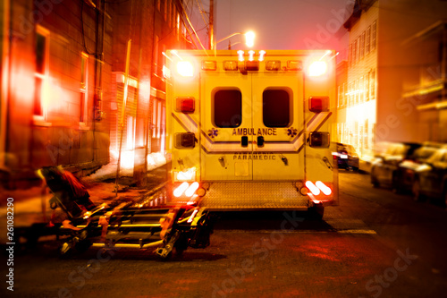 An ambulance car parked on the side street at night