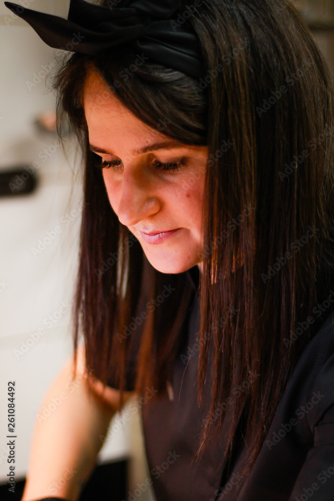 Portrait of a girl chef. Woman in black uniforms. Meet the restaurant chef. Portrait of a girl chef. Woman in black uniforms. Meet the restaurant chef.