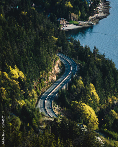 An overhead view of a coastal highway at sunset