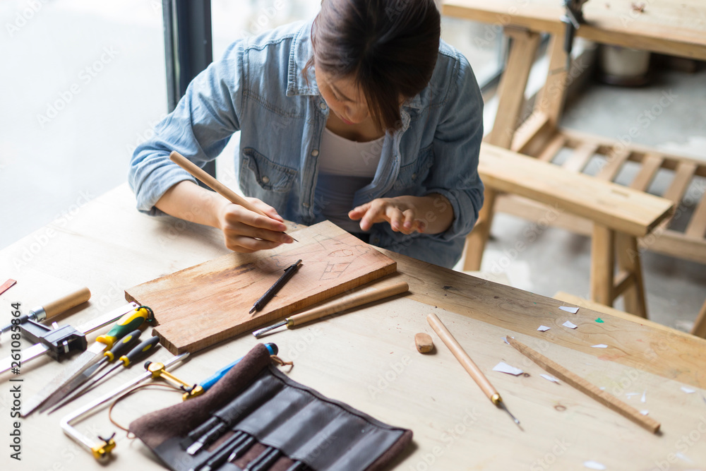 Female carpenter working in studio Female carpenter working in studio