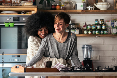 Two beautiful girls having fun while have breakfast in them home. photo