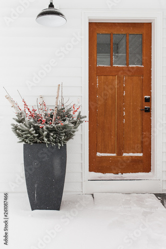 Christmas decorations by wood entry door
