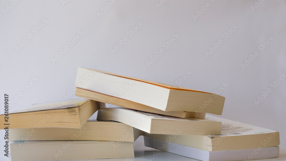 Heap of books isolated on white background. - obrazy, fototapety, plakaty 