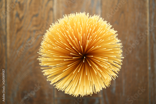 Directly above shot of raw spaghetti on wooden background photo