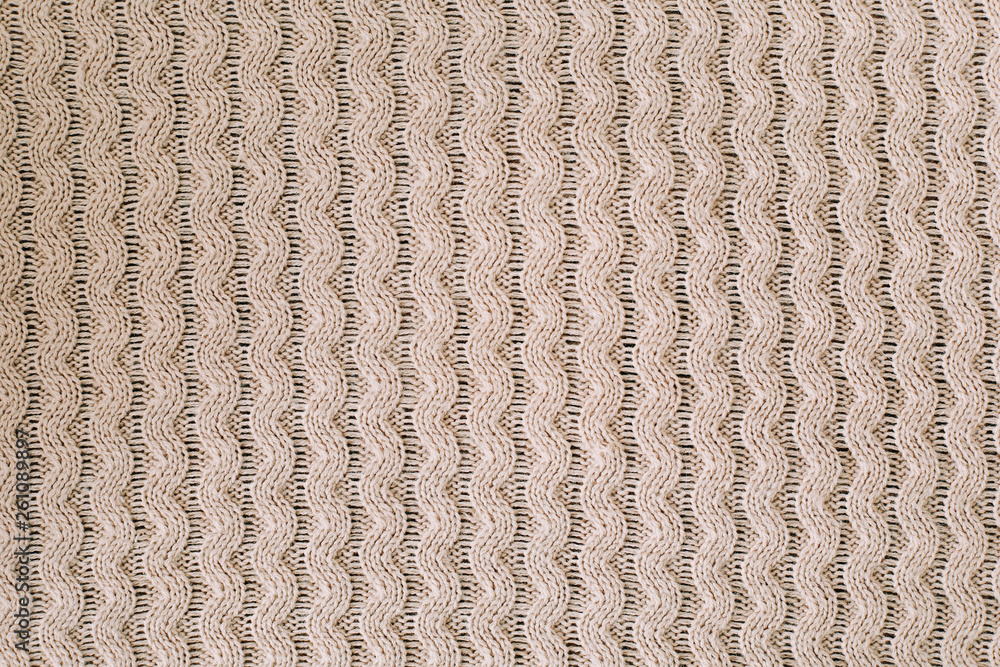 Knitted background. Knitting pattern of wool. Knitting. Texture of knitted woolen  fabric for wallpaper and an abstract background