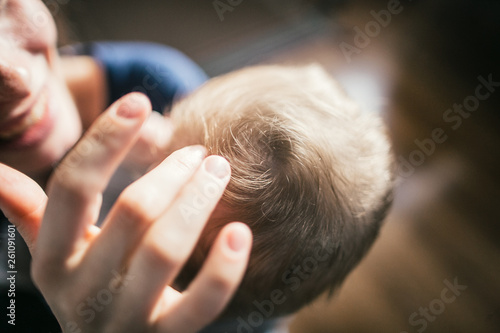mother strokes the head of her son
