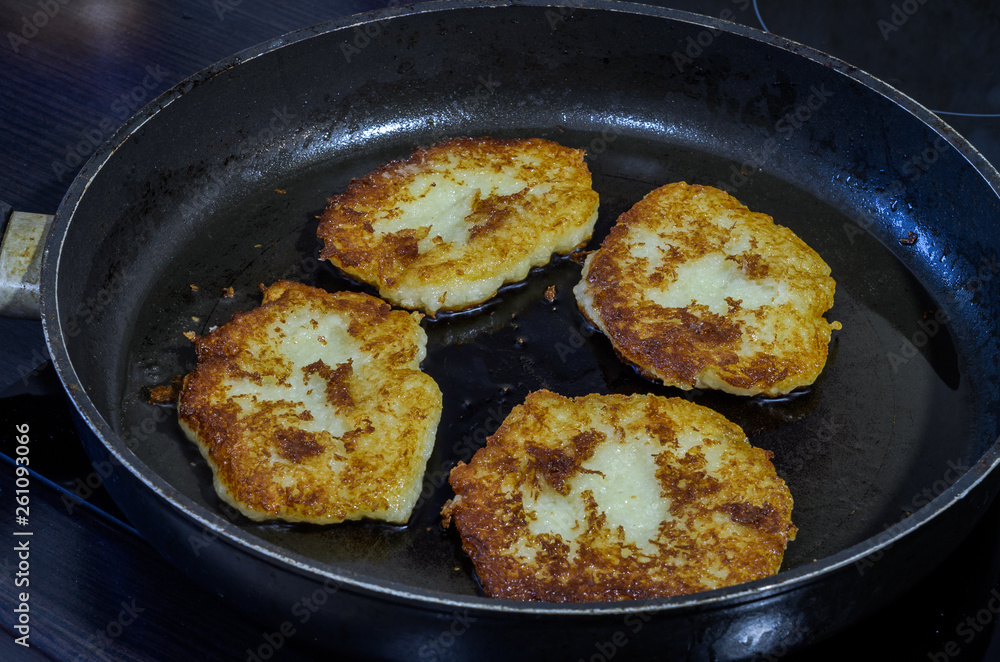 Potato cakes fried in a frying pan in sunflower oil