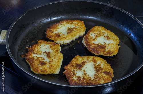 Potato cakes fried in a frying pan in sunflower oil