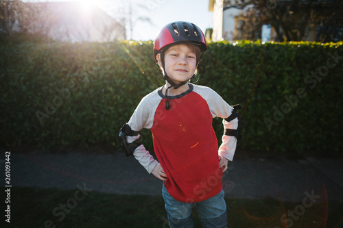 Kid wearing bike gear and helmet.