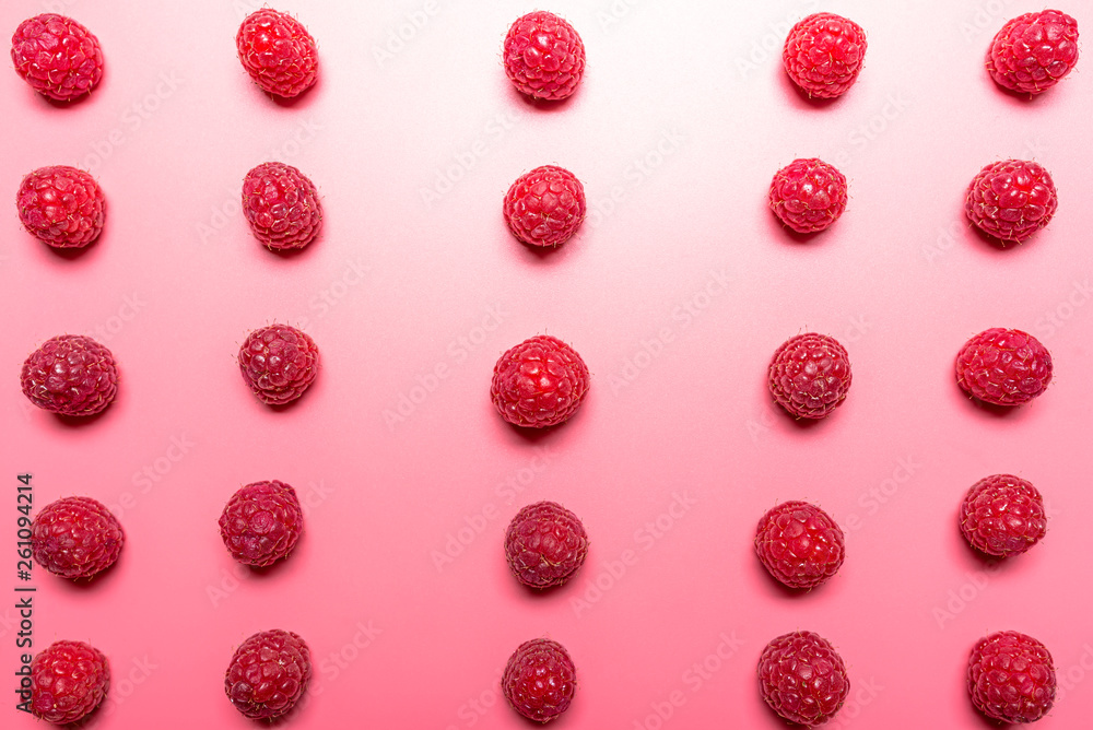 Pattern made from fresh raspberries, top view, flat lay pattern, isolated on a light pink background. Pattern made from fresh raspberries, top view, flat lay pattern, isolated on a light pink background.
