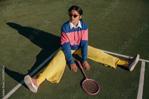 Stylish asian female with tennis racket