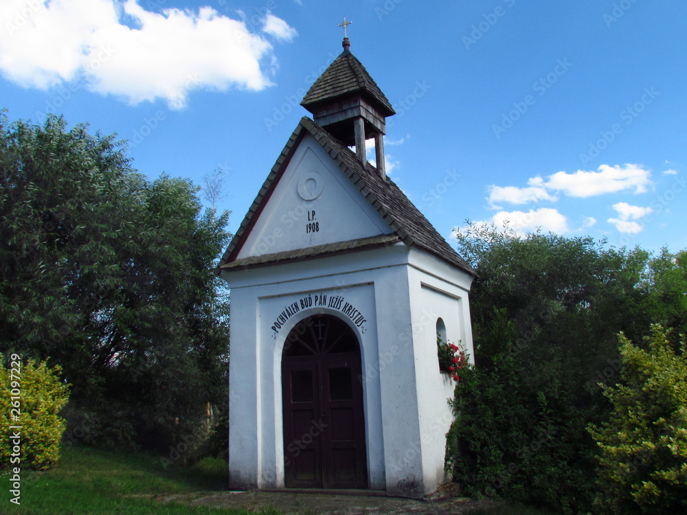 Rural chapel, typical village folk architecture, rural impression, inscription Blessed be Jesus Christ Rural chapel, typical village folk architecture, rural impression, inscription Blessed be Jesus Christ