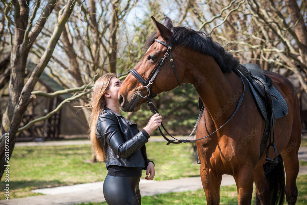 Obraz premium Woman on a horse at rancho. Horse riding, hobby time. Concept of animals and human 