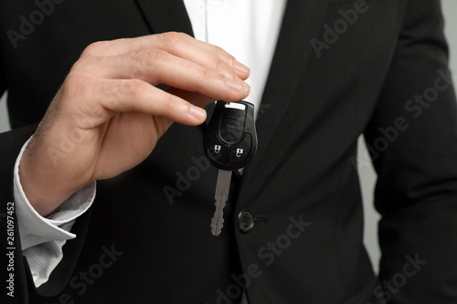 Young man holding new car key, closeup
