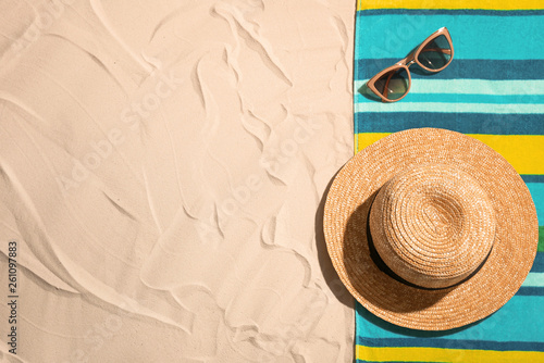 Flat lay composition with beach objects and space for text on sand