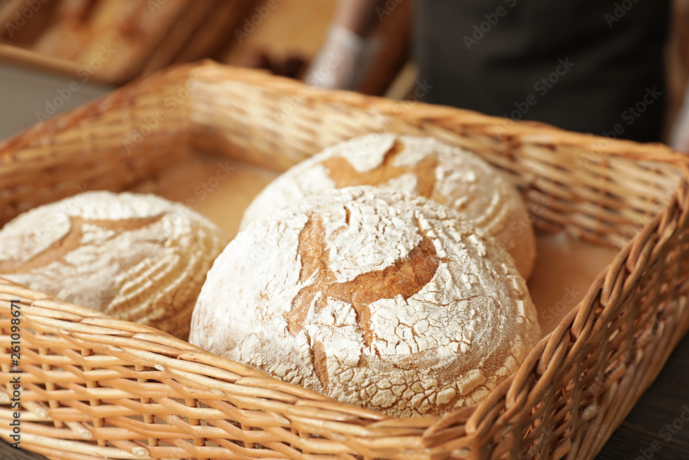 Wicker tray with fresh loaves of bread in bakery Wicker tray with fresh loaves of bread in bakery