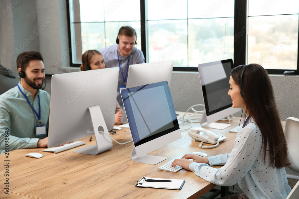 Technical support operators working in modern office Technical support operators working in modern office