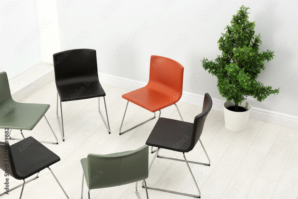 Fototapeta premium Chairs prepared for group therapy session in office. Meeting room interior