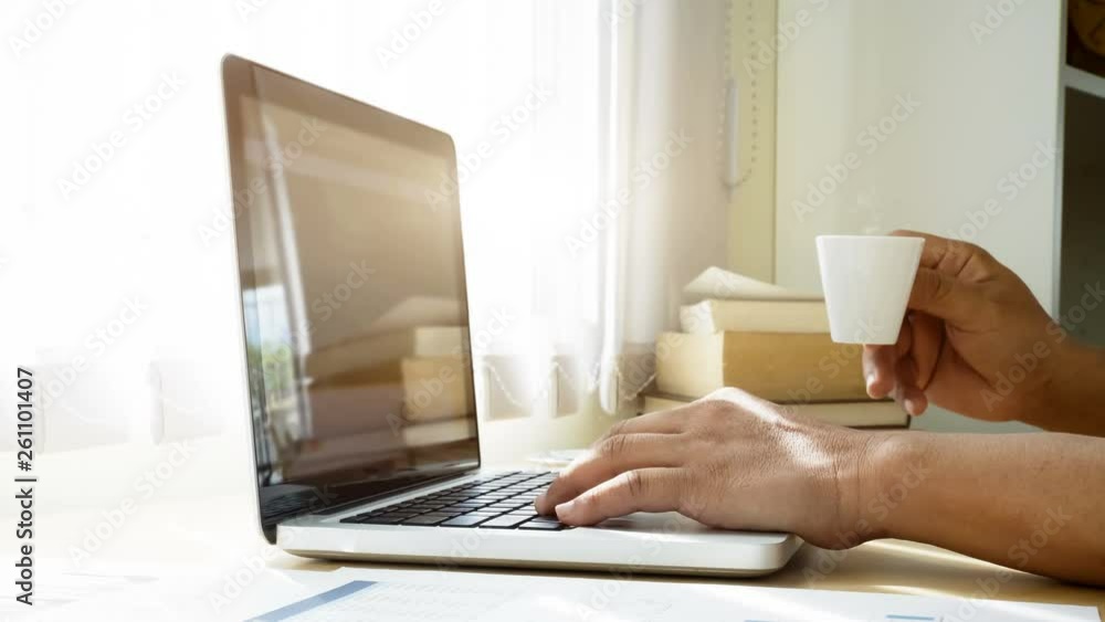 Cinemagraph of steaming coffee on desk of man who using computer laptop. Cinemagraph of steaming coffee on desk of man who using computer laptop.