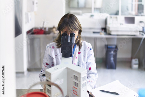 Lab technician with microscope photo