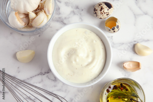 Flat lay composition with garlic sauce on marble background