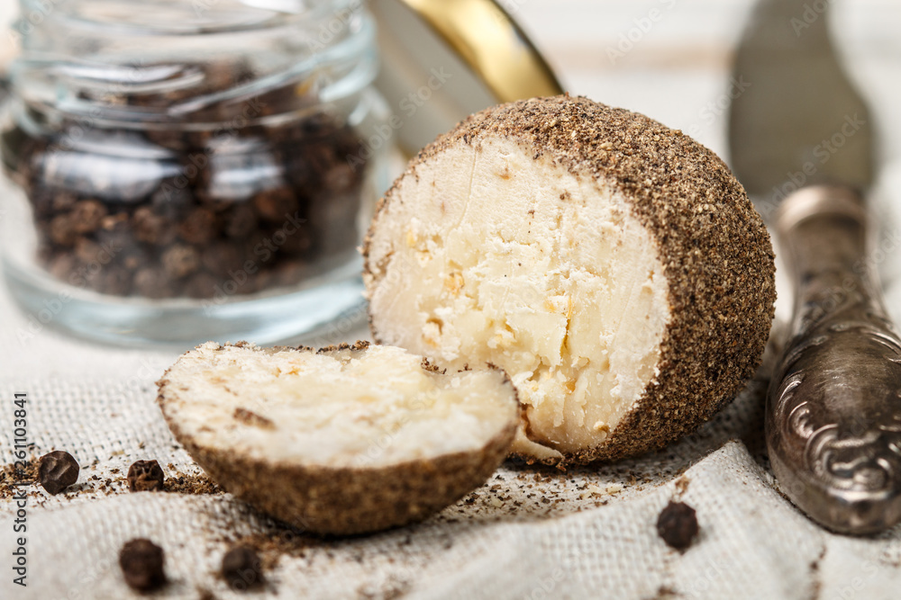 Delicacy round small cheese with black pepper and garlic. Belper knolle. Spicy appetizer for gourmets. Selective focus Delicacy round small cheese with black pepper and garlic. Belper knolle. Spicy appetizer for gourmets. Selective focus