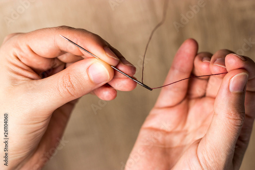 Hands with needle and thread